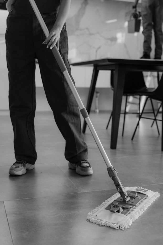Person Cleaning a Tiled Floor